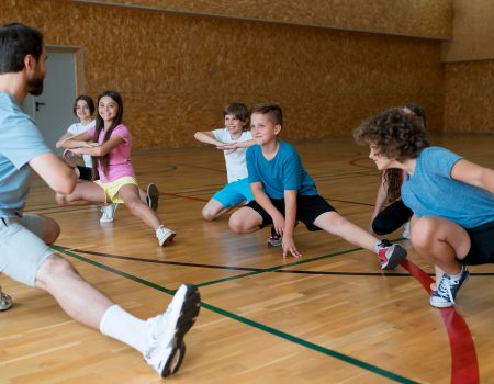 medium-shot-kids-exercising-school-gym