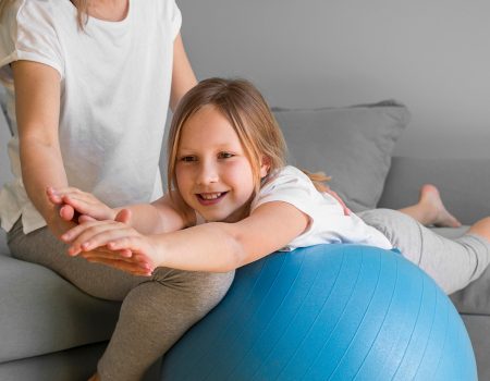 mom-helping-girl-exercise-ball