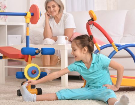 senior-woman-little-granddaughter-doing-exercise-home